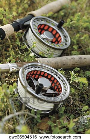 Stock Photograph - High angle view of two fishing reels and fishing rods. Fotosearch