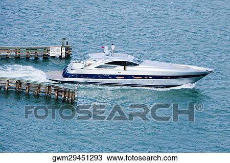 High angle view of two people standing on a motorboat View Large Photo Image Stock Image - High angle view of two people standing on a motorboat. Fotosearch