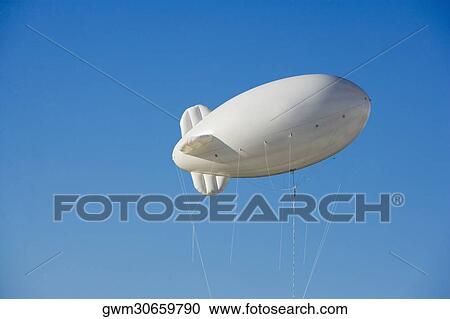 Low angle view of a blimp in the sky View Large Photo Image Stock Image - Low angle view of a blimp in the sky. Fotosearch