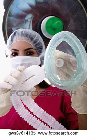 Low angle view of a female surgeon holding an oxygen mask View Large Photo Image Stock Photography - Low angle view of a female surgeon holding an oxygen mask. Fotosearch
