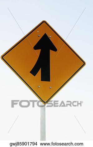 Low angle view of a merging sign View Large Photo Image Picture - Low angle view of a merging sign. Fotosearch