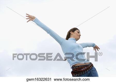 Low angle view of a mid adult woman with her arms outstretched View Large Photo Image Stock Image - Low angle view of a mid adult woman with her arms outstretched. Fotosearch