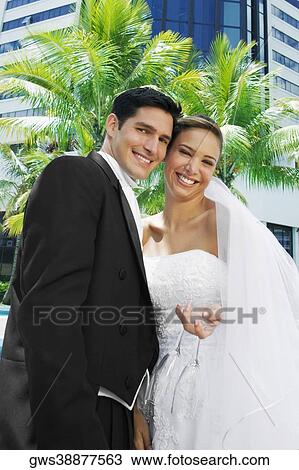Low angle view of a newlywed couple smiling View Large Photo Image Stock Image - Low angle view of a newlywed couple smiling. Fotosearch
