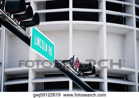 Low angle view of a street name sign mounted on a traffic light View Large Photo Image Stock Photo - Low angle view of a street name sign mounted on a traffic light. Fotosearch