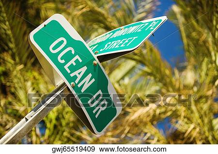 Low angle view of a street name sign View Large Photo Image Stock Photo - Low angle view of a street name sign. Fotosearch