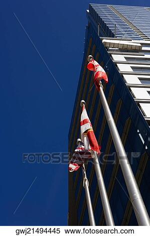 Low angle view of flags in front of a building, Miami, Florida, USA View Large Photo Image Stock Photography - Low angle view of flags in front of a building, Miami, Florida, USA. Fotosearch