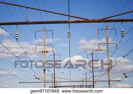 Stock Photo - Low angle view of power cables over railroad tracks. Fotosearch