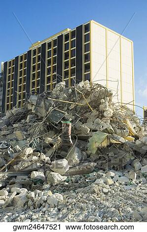 Stock Image - Low angle view of rubble in front of a building. Fotosearch