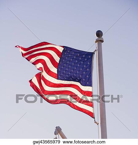 Stock Photo - Low angle view of the American flag. Fotosearch