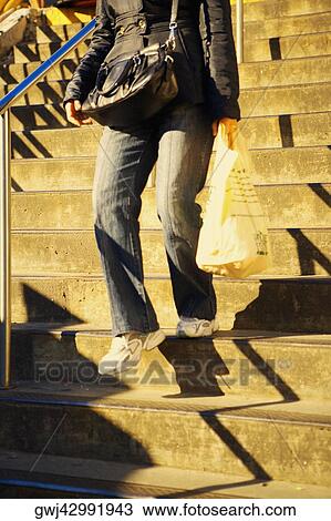 Low section view of a man walking down stairs View Large Photo Image Stock Image - Low section view of a man walking down stairs. Fotosearch