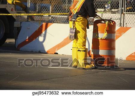 Low section view of a manual worker standing near a garbage bin View Large Photo Image Stock Image - Low section view of a manual worker standing near a garbage bin. Fotosearch