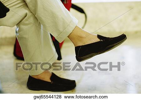 Low section view of a person sitting View Large Photo Image Stock Photo - Low section view of a person sitting. Fotosearch