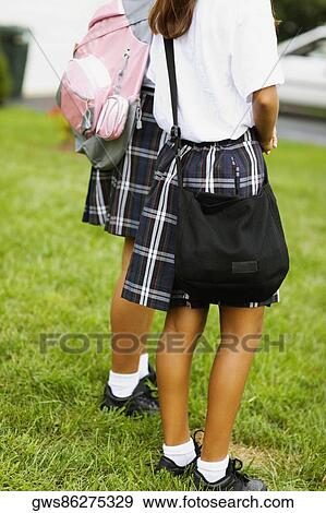 Low section view of two schoolgirls carrying schoolbags View Large Photo Image Stock Photo - Low section view of two schoolgirls carrying schoolbags. Fotosearch