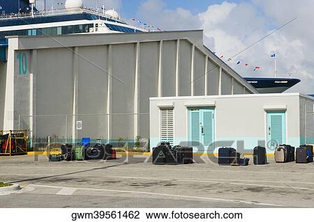 Stock Image - Luggage in front of an industrial building. Fotosearch