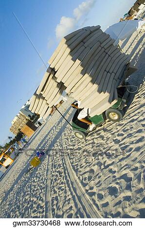 Man driving a vehicle with a stack of duvet on the beach View Large Photo Image Stock Photo - Man driving a vehicle with a stack of duvet on the beach. Fotosearch