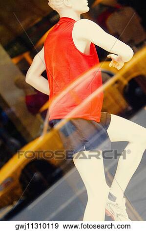 Mannequin behind the glass of a clothing store and reflection of a car on it View Large Photo Image Stock Photo - Mannequin behind the glass of a clothing store and reflection of a car on it. Fotosearch