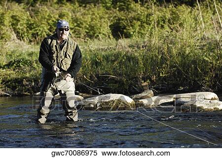 Mature man fishing in the river View Large Photo Image Stock Photography - Mature man fishing in the river. Fotosearch