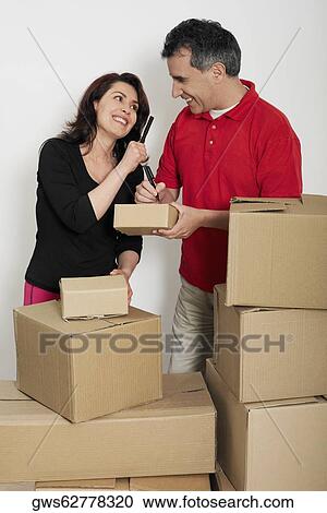 Mid adult couple looking at each other and smiling View Large Photo Image Stock Image - Mid adult couple looking at each other and smiling. Fotosearch