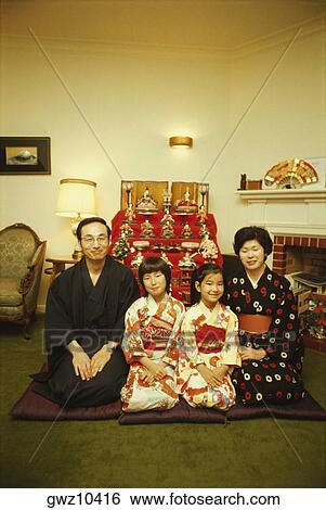 Mid adult couple sitting with their two daughters in front of dolls at a traditional doll festival, Hinamatsuri, Tokyo Prefecture, Japan View Large Photo Image Stock Photograph - Mid adult couple sitting with their two daughters in front of dolls at a traditional doll festival, Hinamatsuri, Tokyo Prefecture, Japan. Fotosearch