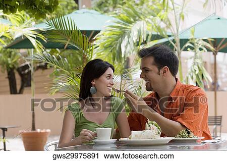 Mid adult man feeding a teenage girl with a fork at a restaurant View Large Photo Image Stock Image - Mid adult man feeding a teenage girl with a fork at a restaurant. Fotosearch