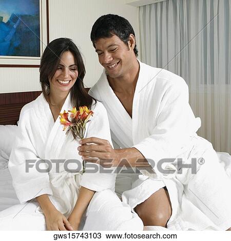Mid adult man giving flowers to a young woman View Large Photo Image Stock Image - Mid adult man giving flowers to a young woman. Fotosearch