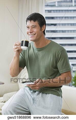 Mid adult man holding a cup of tea View Large Photo Image Stock Photograph - Mid adult man holding a cup of tea. Fotosearch