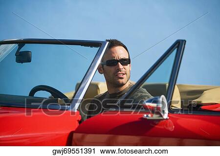 Mid adult man sitting in a convertible car, Miami, Florida, USA View Large Photo Image Stock Image - Mid adult man sitting in a convertible car, Miami, Florida, USA. Fotosearch