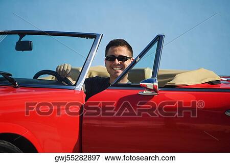 Mid adult man sitting in a convertible car, Miami, Florida, USA View Large Photo Image Stock Photo - Mid adult man sitting in a convertible car, Miami, Florida, USA. Fotosearch