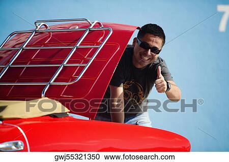 Mid adult man standing behind a convertible car, Miami, Florida, USA View Large Photo Image Stock Image - Mid adult man standing behind a convertible car, Miami, Florida, USA. Fotosearch