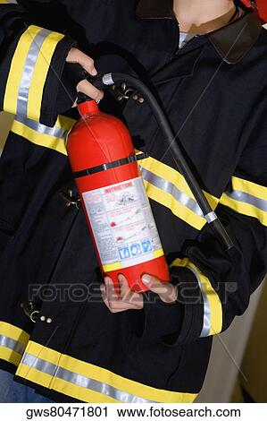 Mid section view of a boy dressed as a firefighter and holding a fire extinguisher View Large Photo Image Stock Image - Mid section view of a boy dressed as a firefighter and holding a fire extinguisher. Fotosearch