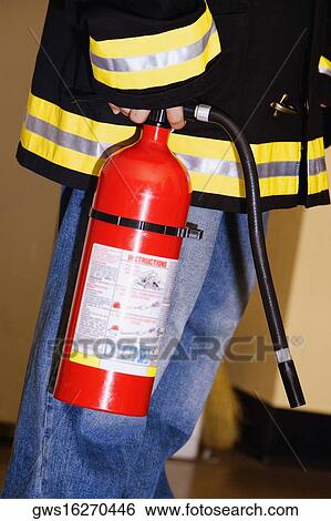 Mid section view of a boy dressed as a firefighter and holding a fire extinguisher View Large Photo Image Stock Photograph - Mid section view of a boy dressed as a firefighter and holding a fire extinguisher. Fotosearch