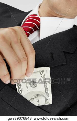 Mid section view of a businessman putting dollar bills in his pocket View Large Photo Image Stock Image - Mid section view of a businessman putting dollar bills in his pocket. Fotosearch