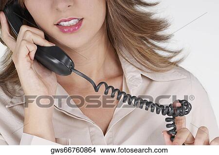 Mid section view of a businesswoman talking on the telephone View Large Photo Image Picture - Mid section view of a businesswoman talking on the telephone. Fotosearch