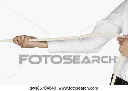 Stock Image - Mid section view of a businesswoman pulling a rope. Fotosearch