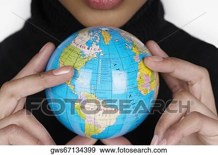 Mid section view of a businesswoman holding a globe View Large Photo Image Stock Photo - Mid section view of a businesswoman holding a globe. Fotosearch