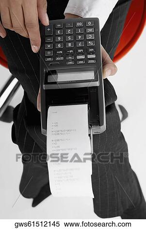 Mid section view of a businesswoman holding an adding machine tape View Large Photo Image Stock Photography - Mid section view of a businesswoman holding an adding machine tape. Fotosearch