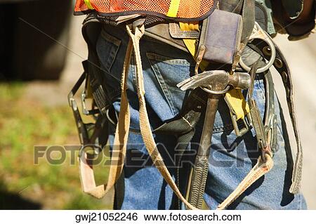 Mid section view of a construction worker View Large Photo Image Stock Photograph - Mid section view of a construction worker. Fotosearch