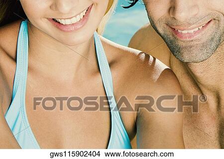 Mid section view of a man and woman View Large Photo Image Picture - Mid section view of a man and woman. Fotosearch