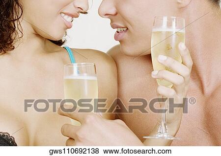 Mid section view of a man and woman holding champagne flutes View Large Photo Image Stock Photo - Mid section view of a man and woman holding champagne flutes. Fotosearch