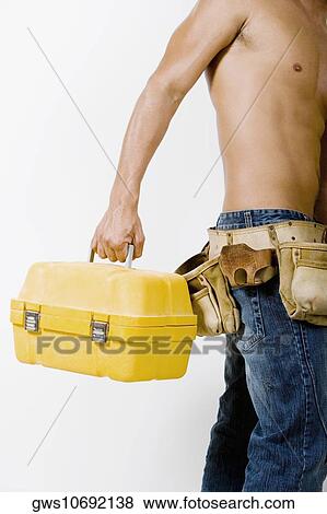 Mid section view of a man holding a toolbox View Large Photo Image Stock Photo - Mid section view of a man holding a toolbox. Fotosearch