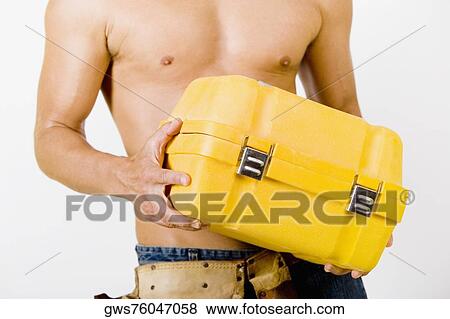 Mid section view of a man holding a toolbox View Large Photo Image Stock Photo - Mid section view of a man holding a toolbox. Fotosearch
