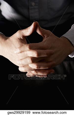 Mid section view of a man sitting with his hands clasped View Large Photo Image Stock Photo - Mid section view of a man sitting with his hands clasped. Fotosearch