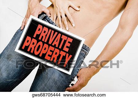 Mid section view of a man standing with a Private Property sign on his crotch and a woman touching his abdomen View Large Photo Image Picture - Mid section view of a man standing with a Private Property sign on his crotch and a woman touching his abdomen. Fotosearch