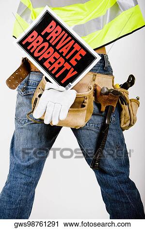 Mid section view of a man wearing a tool belt with a Private Property sign View Large Photo Image Stock Image - Mid section view of a man wearing a tool belt with a Private Property sign. Fotosearch