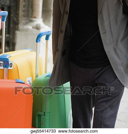 Mid section view of a man with suitcases View Large Photo Image Stock Image - Mid section view of a man with suitcases. Fotosearch