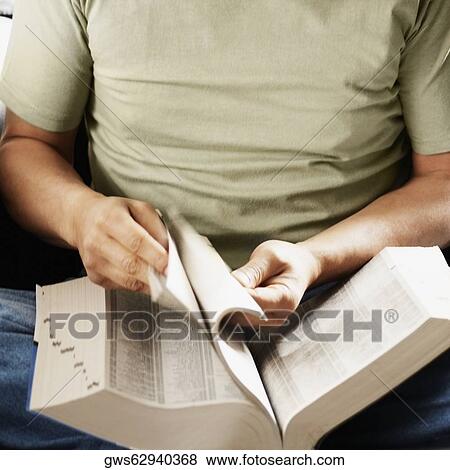 Mid section view of a senior man turning pages of a book View Large Photo Image Stock Photo - Mid section view of a senior man turning pages of a book. Fotosearch