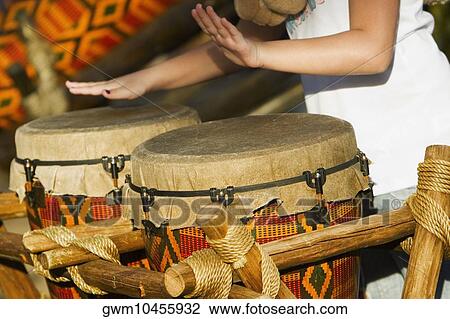 Mid section view of a woman playing drums View Large Photo Image Stock Image - Mid section view of a woman playing drums. Fotosearch