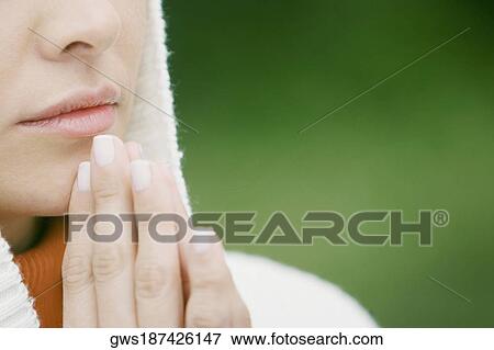 Mid section view of a woman praying View Large Photo Image Stock Photo - Mid section view of a woman praying. Fotosearch