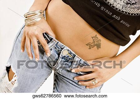 Mid section view of a woman View Large Photo Image Stock Image - Mid section view of a woman. Fotosearch