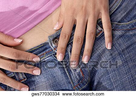 Mid section view of a young woman View Large Photo Image Picture - Mid section view of a young woman. Fotosearch